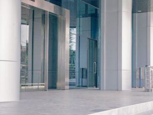 Elegant modern building entrance featuring sleek glass and steel architecture with a minimalist design.