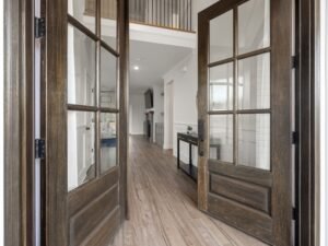 Spacious entrance with elegant wooden double doors leading to a modern interior.